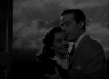 Movie still from “The Uninvited” (1944), directed by Lewis Allen – A man and a woman standing next to each other in front of a cloudy sky; Close Up shot, Low angle