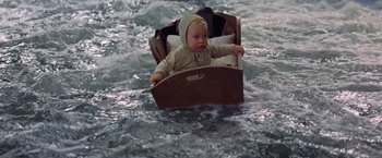 Movie still from “The Unsinkable Molly Brown” (1964), directed by Charles Walters – A baby is in a boat in the middle of the water; Medium shot, High angle