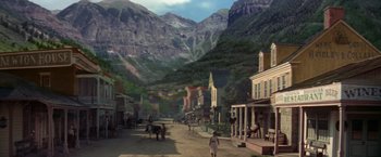Movie still from “The Unsinkable Molly Brown” (1964), directed by Charles Walters – A painting of an old western town in the middle of the mountains; Extreme Wide shot, High angle