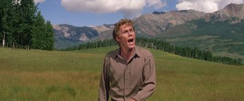 Movie still from “The Unsinkable Molly Brown” (1964), directed by Charles Walters – A man in a field with mountains in the background; Medium shot, Low angle