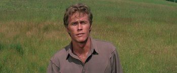 Movie still from “The Unsinkable Molly Brown” (1964), directed by Charles Walters – A man standing in the middle of an open field; Close Up shot, Low angle