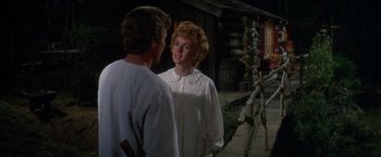 Movie still from “The Unsinkable Molly Brown” (1964), directed by Charles Walters – A man and a woman standing next to each other; Medium shot, Over the shoulder angle