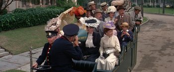 Movie still from “The Unsinkable Molly Brown” (1964), directed by Charles Walters – A group of people sitting on top of a bench; Medium shot, High angle