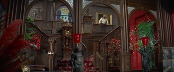 Movie still from “The Unsinkable Molly Brown” (1964), directed by Charles Walters – A statue with a red bucket on it's head in the middle of a staircase; Wide shot, Low angle