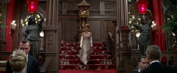 Movie still from “The Unsinkable Molly Brown” (1964), directed by Charles Walters – A woman walking down the stairs in a dress; Wide shot, Low angle