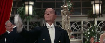Movie still from “The Unsinkable Molly Brown” (1964), directed by Charles Walters – An older man wearing a tuxedo and a bow tie; Medium shot, Low angle