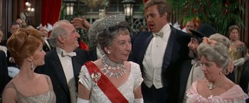 Movie still from “The Unsinkable Molly Brown” (1964), directed by Charles Walters – A woman wearing a tiara and a red and white sash; Close Up shot, Over the shoulder angle