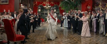Movie still from “The Unsinkable Molly Brown” (1964), directed by Charles Walters – A woman in a white dress and a red sash; Wide shot, Over the shoulder angle