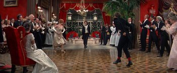Movie still from “The Unsinkable Molly Brown” (1964), directed by Charles Walters – A group of people standing in a room; Wide shot, Over the shoulder angle