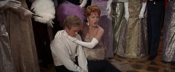 Movie still from “The Unsinkable Molly Brown” (1964), directed by Charles Walters – A man and a woman in formal wear sitting next to each other; Medium shot, Low angle
