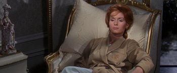 Movie still from “The Unsinkable Molly Brown” (1964), directed by Charles Walters – A woman sitting on a couch in a room; Medium shot, High angle