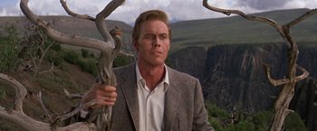 Movie still from “The Unsinkable Molly Brown” (1964), directed by Charles Walters – A man standing next to a dead tree in the middle of a valley; Close Up shot, Low angle