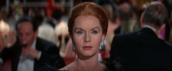 Movie still from “The Unsinkable Molly Brown” (1964), directed by Charles Walters – An older woman wearing a dress and a fur coat; Close Up shot, Over the shoulder angle