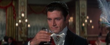Movie still from “The Unsinkable Molly Brown” (1964), directed by Charles Walters – A person holding a glass of wine; Close Up shot, High angle