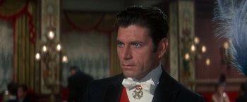 Movie still from “The Unsinkable Molly Brown” (1964), directed by Charles Walters – A person wearing a suit and tie; Close Up shot, Over the shoulder angle