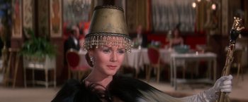 Movie still from “The Unsinkable Molly Brown” (1964), directed by Charles Walters – A woman wearing a hat with a veil on top of her head; Close Up shot, Low angle