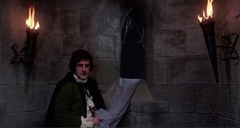 Movie still from “The Vampire Lovers” (1970), directed by Roy Ward Baker – A man in a green jacket holding a white umbrella; Medium shot, Low angle