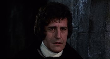 Movie still from “The Vampire Lovers” (1970), directed by Roy Ward Baker – A person wearing a suit and tie; Close Up shot, Over the shoulder angle