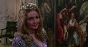 Movie still from “The Vampire Lovers” (1970), directed by Roy Ward Baker – A woman with long blonde hair wearing a tiara; Close Up shot, Over the shoulder angle