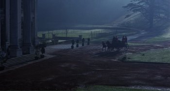 Movie still from “The Vampire Lovers” (1970), directed by Roy Ward Baker – A group of people riding on a horse drawn carriage in the dark; Extreme Wide shot, High angle