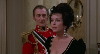 Movie still from “The Vampire Lovers” (1970), directed by Roy Ward Baker – A man and a woman dressed up in military uniforms; Medium shot, Over the shoulder angle