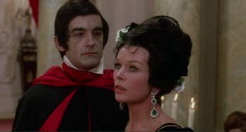 Movie still from “The Vampire Lovers” (1970), directed by Roy Ward Baker – A man and a woman dressed in formal wear; Medium shot, Low angle