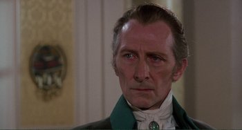 Movie still from “The Vampire Lovers” (1970), directed by Roy Ward Baker – A person wearing a suit and tie; Close Up shot, Over the shoulder angle