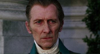 Movie still from “The Vampire Lovers” (1970), directed by Roy Ward Baker – A person wearing a suit and tie; Close Up shot, Low angle