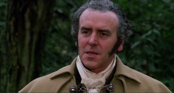 Movie still from “The Vampire Lovers” (1970), directed by Roy Ward Baker – An older man wearing a coat and a chain around his neck; Close Up shot, Low angle