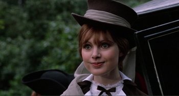 Movie still from “The Vampire Lovers” (1970), directed by Roy Ward Baker – A woman in a brown hat and a white shirt; Close Up shot, Over the shoulder angle