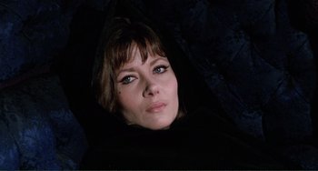 Movie still from “The Vampire Lovers” (1970), directed by Roy Ward Baker – A person wearing a black robe; Close Up shot, Low angle