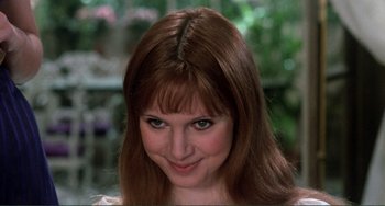 Movie still from “The Vampire Lovers” (1970), directed by Roy Ward Baker – A person with long brown hair; Close Up shot, Over the shoulder angle