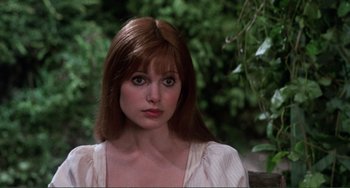 Movie still from “The Vampire Lovers” (1970), directed by Roy Ward Baker – A person wearing a dress; Close Up shot, Over the shoulder angle