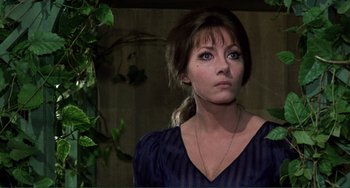 Movie still from “The Vampire Lovers” (1970), directed by Roy Ward Baker – A woman in a blue shirt is looking at the camera; Close Up shot, Low angle