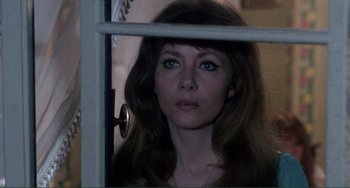 Movie still from “The Vampire Lovers” (1970), directed by Roy Ward Baker – A woman with long brown hair looking out a window; Close Up shot, Low angle