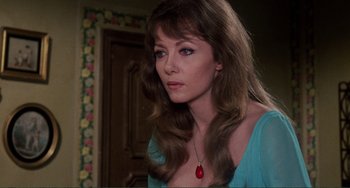 Movie still from “The Vampire Lovers” (1970), directed by Roy Ward Baker – A woman in a blue shirt is looking at the camera; Close Up shot, Over the shoulder angle