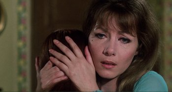 Movie still from “The Vampire Lovers” (1970), directed by Roy Ward Baker – A person with their hand on the face of another person; Close Up shot, Over the shoulder angle