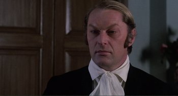 Movie still from “The Vampire Lovers” (1970), directed by Roy Ward Baker – A person wearing a suit and tie; Close Up shot, Low angle