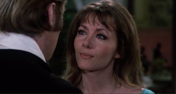 Movie still from “The Vampire Lovers” (1970), directed by Roy Ward Baker – A person wearing a suit and tie; Close Up shot, Over the shoulder angle