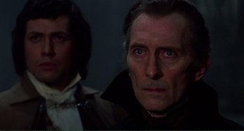 Movie still from “The Vampire Lovers” (1970), directed by Roy Ward Baker – A man in a brown jacket and a man in a black jacket; Close Up shot, Over the shoulder angle