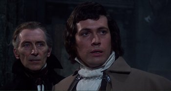 Movie still from “The Vampire Lovers” (1970), directed by Roy Ward Baker – A person wearing a suit and tie; Close Up shot, Over the shoulder angle