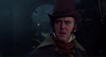 Movie still from “The Vampire Lovers” (1970), directed by Roy Ward Baker – A person wearing a hat; Close Up shot, Over the shoulder angle