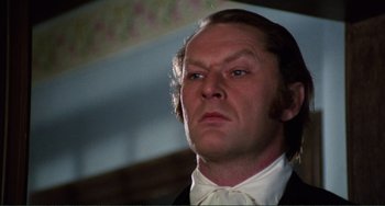 Movie still from “The Vampire Lovers” (1970), directed by Roy Ward Baker – A person wearing a suit and bow tie; Close Up shot, Low angle