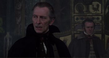 Movie still from “The Vampire Lovers” (1970), directed by Roy Ward Baker – A person wearing a suit and tie; Close Up shot, Over the shoulder angle