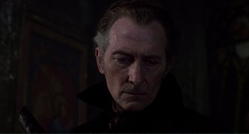 Movie still from “The Vampire Lovers” (1970), directed by Roy Ward Baker – A person wearing a suit and tie; Close Up shot, Low angle