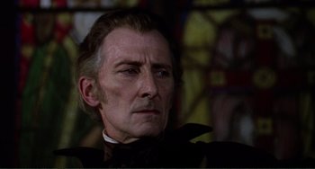 Movie still from “The Vampire Lovers” (1970), directed by Roy Ward Baker – A person wearing a suit and tie; Close Up shot, Low angle