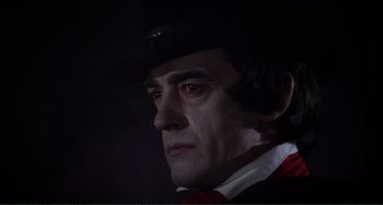 Movie still from “The Vampire Lovers” (1970), directed by Roy Ward Baker – A person wearing a hat; Close Up shot, Low angle