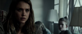 Movie still from “The Veil” (2016), directed by Phil Joanou – A woman sitting on a couch in a living room; Close Up shot, Over the shoulder angle