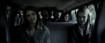 Movie still from “The Veil” (2016), directed by Phil Joanou – A group of people sitting in the back of a car; Medium shot, Over the shoulder angle