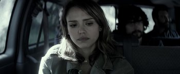 Movie still from “The Veil” (2016), directed by Phil Joanou – A woman sitting in the back of a car looking sad; Close Up shot, Over the shoulder angle